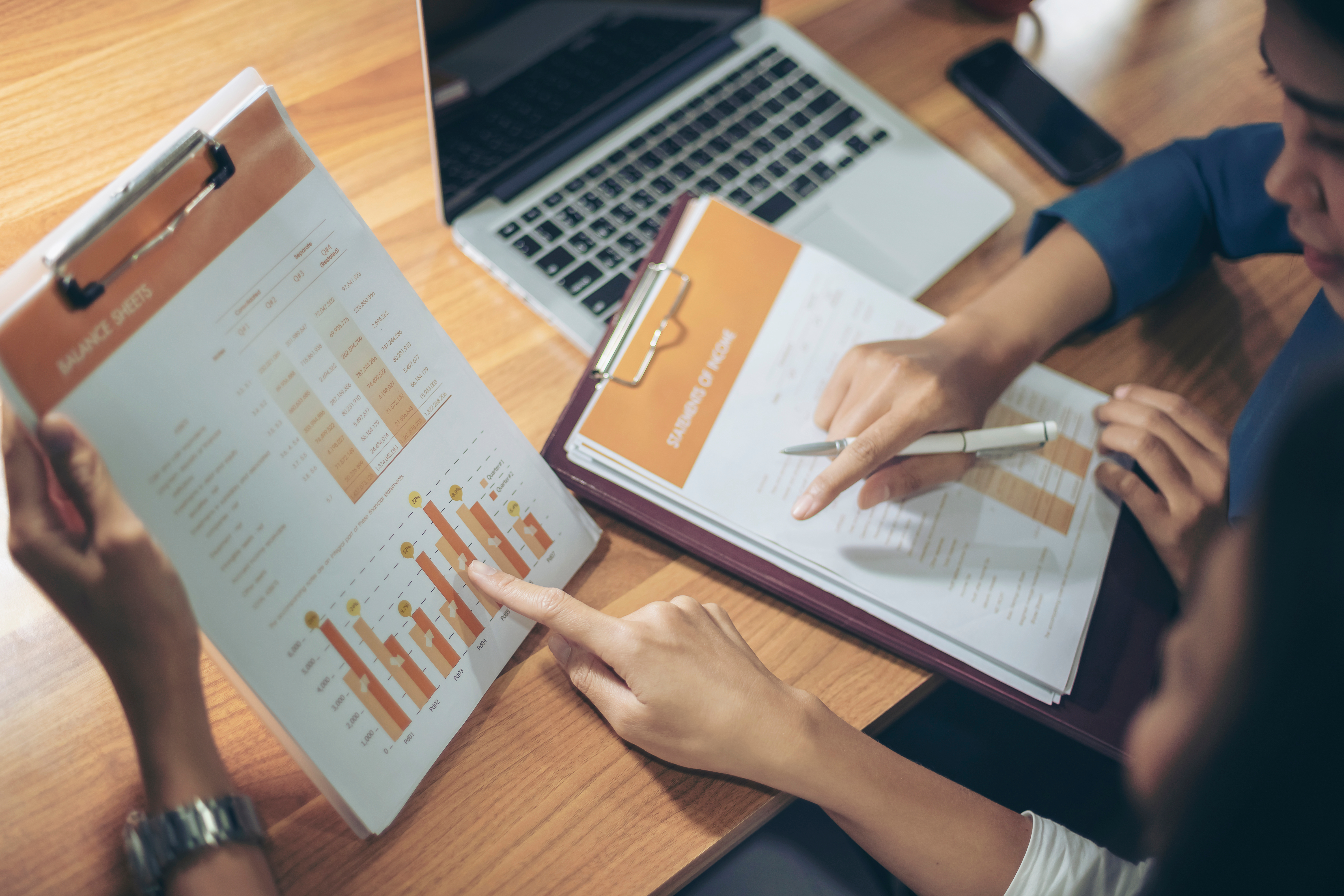 Two women discussing financial matters at a training session